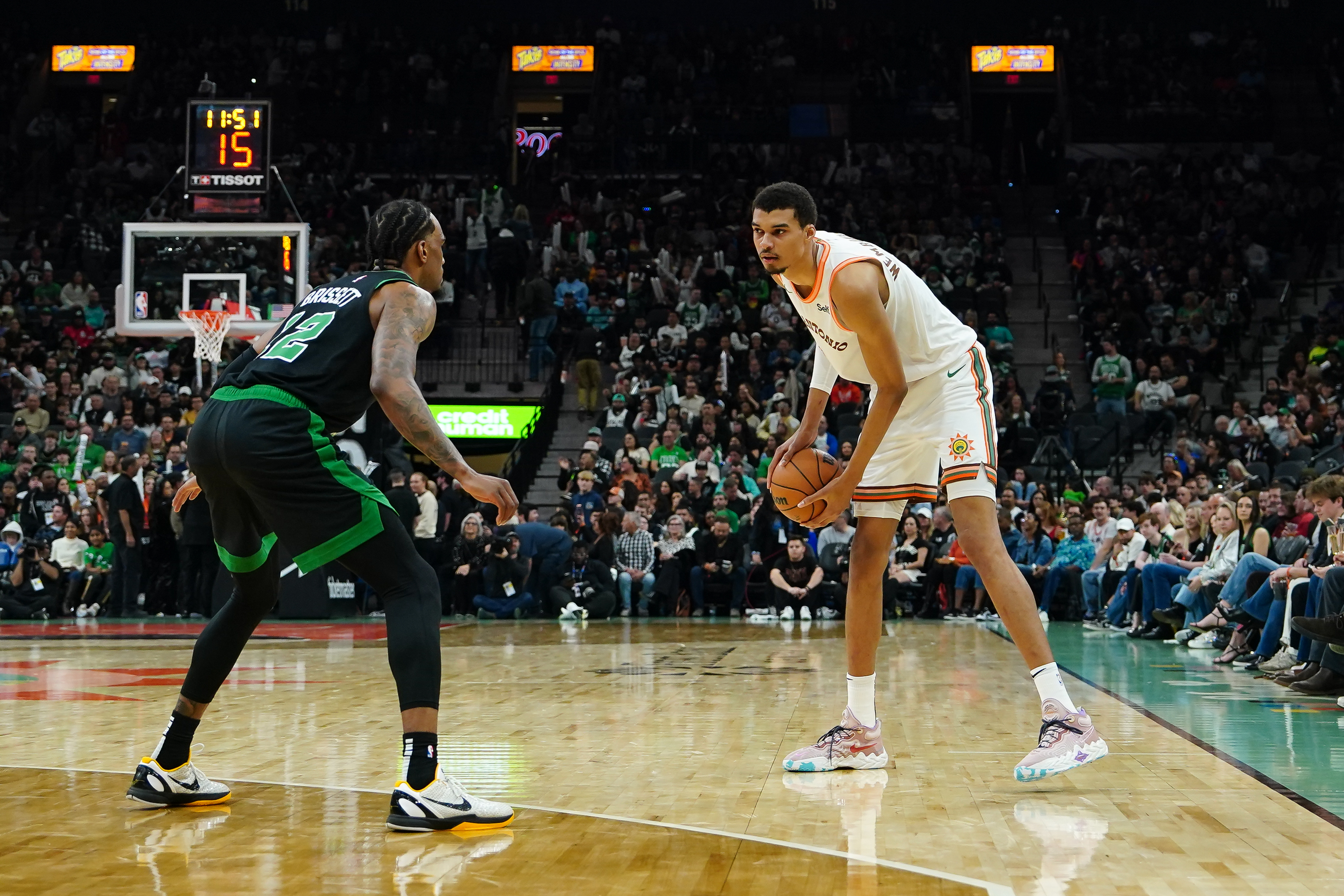 Dec 31, 2023; San Antonio, Texas, USA; San Antonio Spurs center Victor Wembanyama (1) faces off against Boston Celtics forward Oshae Brissett (12) in the second half at Frost Bank Center.